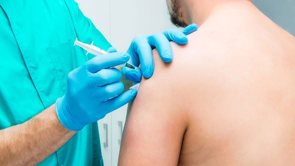 Pain doctor gives patient a shoulder injection