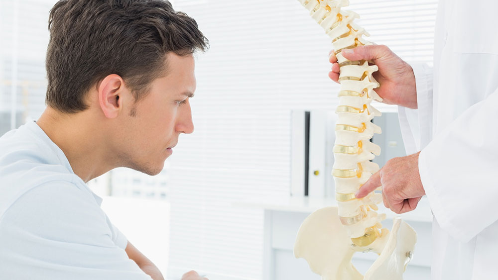 Doctor explaining the source of pain to a patient in the office.